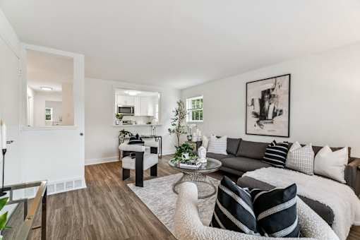 A modern living room with a grey couch and a coffee table.