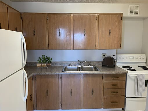 Kitchen with Wood Cabinets and White Appliances