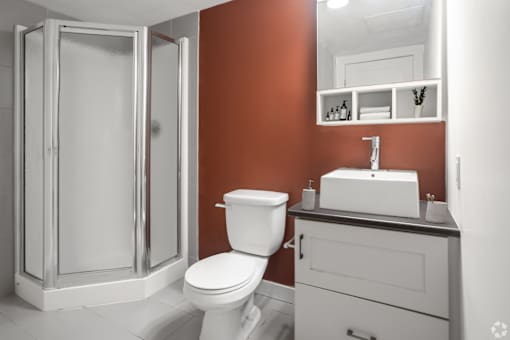 A white toilet sits next to a sink in a bathroom.