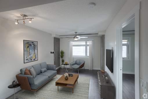 A living room with a grey sofa and a wooden coffee table.