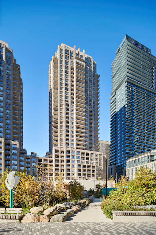 A cityscape with tall buildings and a clear blue sky.
