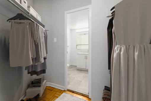 A hallway with a white door and a white wall.
