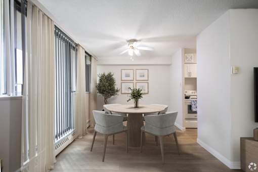 A dining room with a table and chairs.