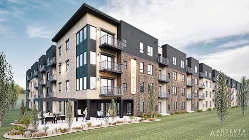 A modern apartment complex with balconies and a landscaped courtyard.