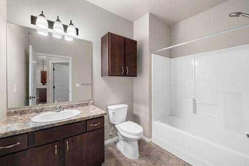 A bathroom with a sink, toilet, and bathtub.
