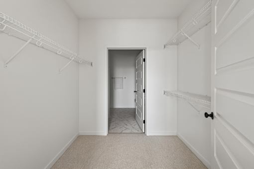 A white room with a doorway leading to another room.