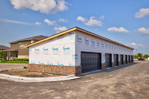 A Tyvek building under construction with a clear blue sky.