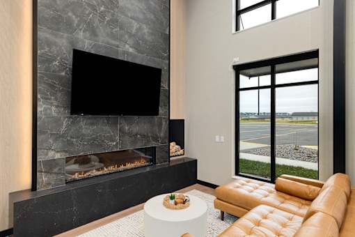 A modern living room with a fireplace and a flat screen TV.