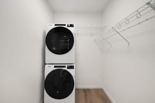 A white washing machine and dryer in a small laundry room.