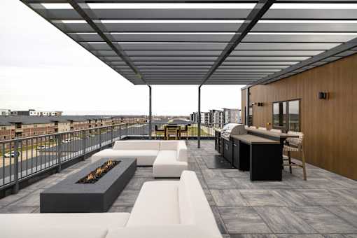 A patio with a fire pit and seating area.