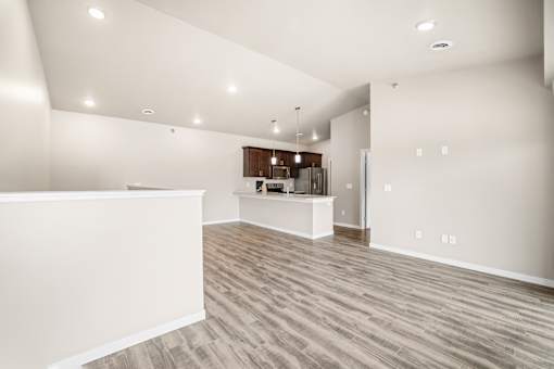A spacious room with wooden flooring and a white reception desk.