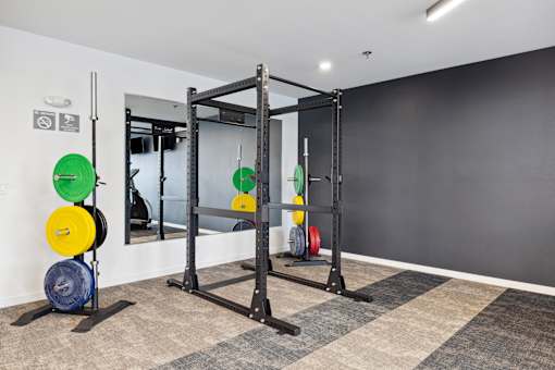 A gym with a weight lifting area.