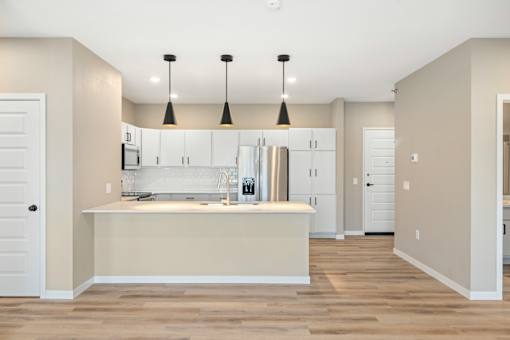 A kitchen with a white counter and cabinets.