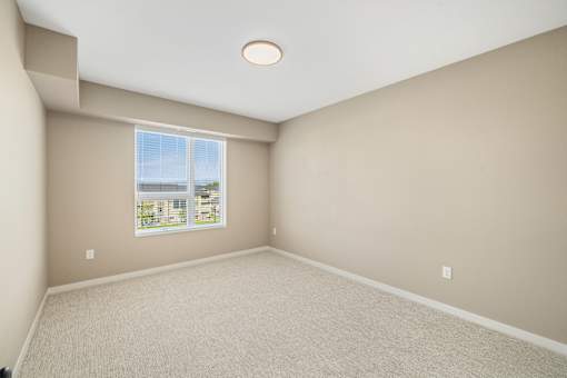 A room with a window overlooking a cityscape.