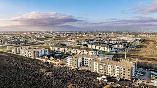 an aerial view of a city with new apartment buildings