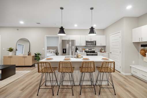 a large dining room with tables and chairs and white walls