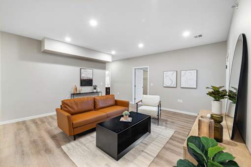 a living room with a leather couch and a coffee table
