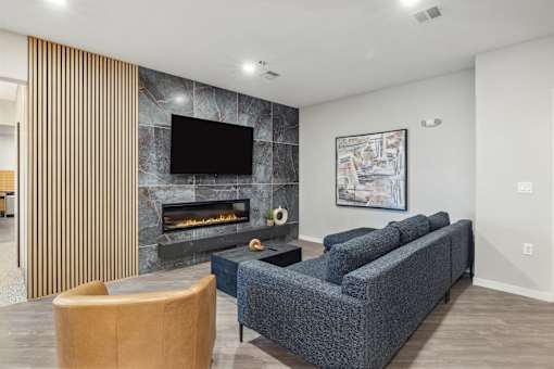 a living room with a couch and a chair and a fireplace