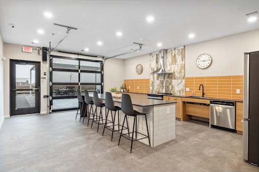 a kitchen with an island and chairs in front of a door