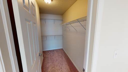 A white door with a brown carpet in front of it.