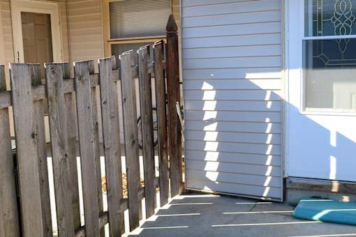 A wooden fence in front of a house.
