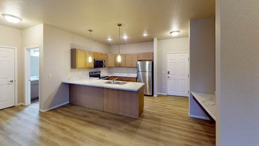 A kitchen with a wooden island and stainless steel appliances.
