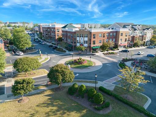 A roundabout in a city with buildings around it.