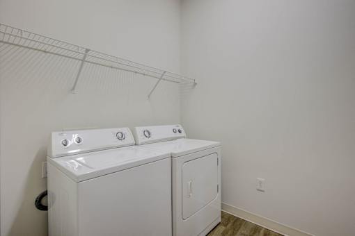 A white washer and dryer in a laundry room.