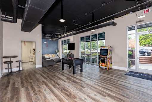 A room with wooden floors and a piano.