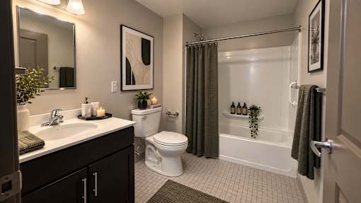 A bathroom with a white toilet, a white sink, and a white bathtub.
