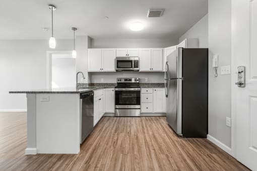 a kitchen with white cabinets and stainless steel appliances