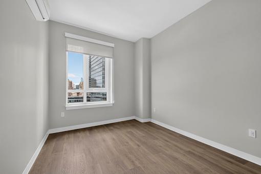A room with a window overlooking a cityscape.