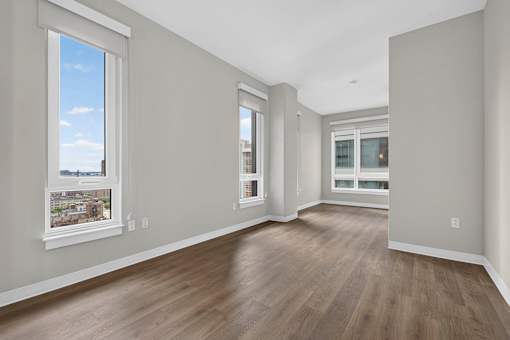 A room with wooden floors and white walls.