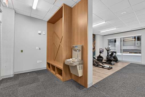 A room with a wooden cabinet and a white sink.