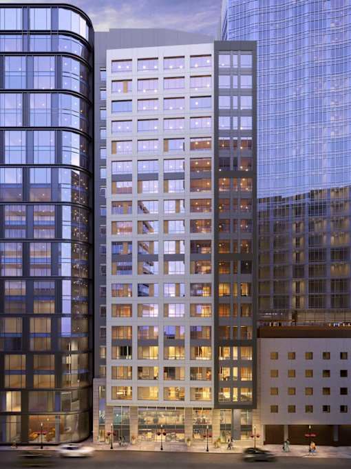A modern building with a curved glass facade stands next to a building with a grid-like facade.