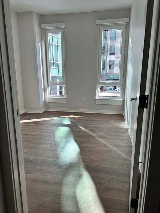 A room with a window and a door.