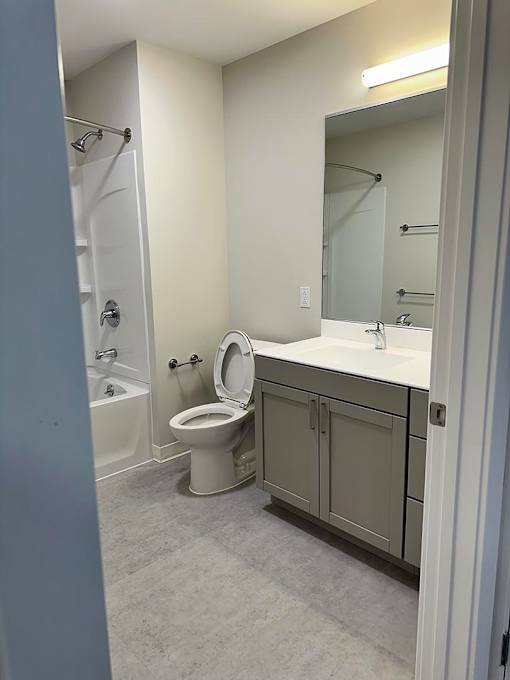 A bathroom with a toilet, sink, and bathtub.