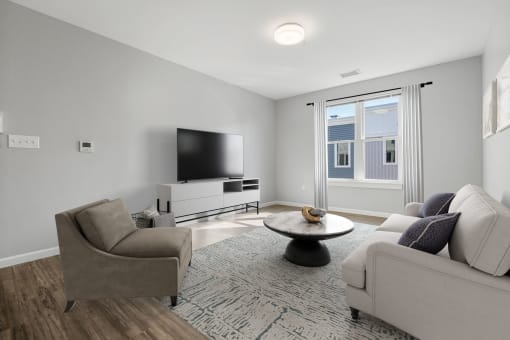 a living room with two couches and a table and a tv