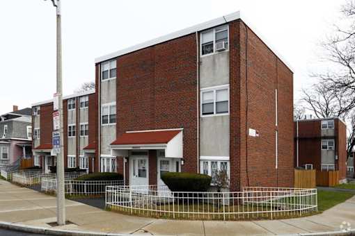 A red brick building with a white door and windows.