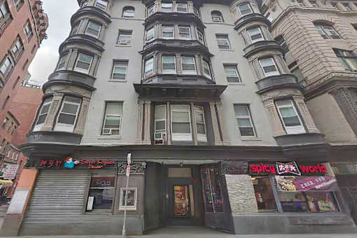A building with a Spicy World sign on the front.