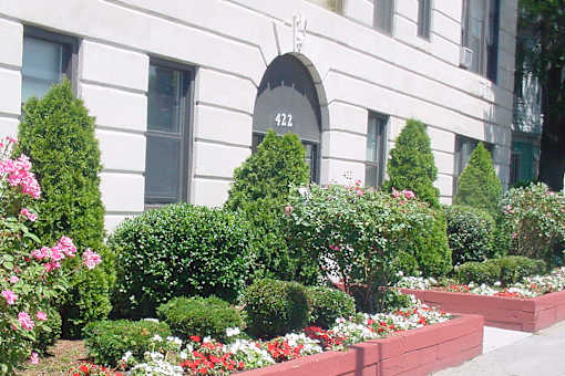 White stone building with landscaping