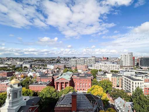 A cityscape with buildings of various sizes and a clear sky.