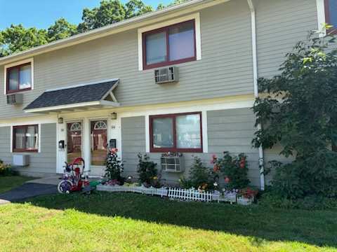 A house with a red bike in front of it.