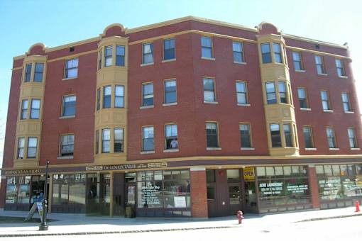 A red brick building with a yellow trim.