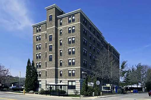 A tall building with a black fence in front of it.