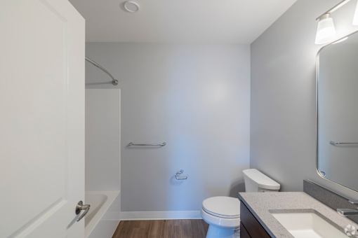 A white toilet sits next to a sink in a small bathroom.