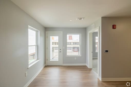 A room with a white wall and a window.