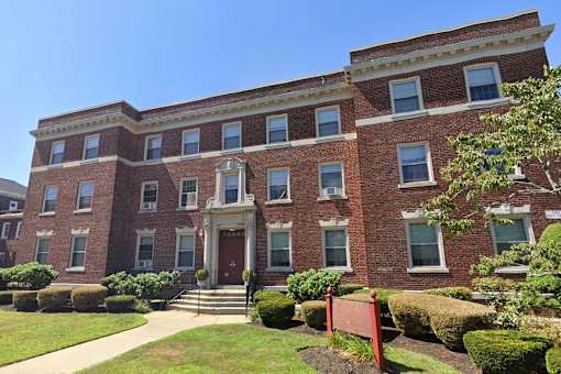 A red brick building - three stories, nice landscaping