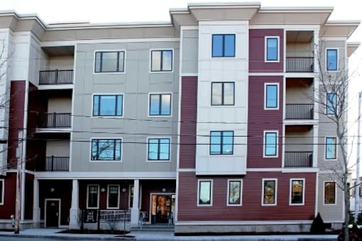 Apartment building with balconies and doors.