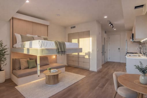 A modern bedroom with a built-in bed and a seating area.